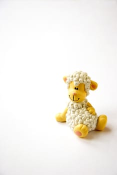 Funny lamb shaped toy isolated on a white background