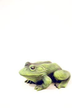 Green frog - a souvenir isolated on a white background