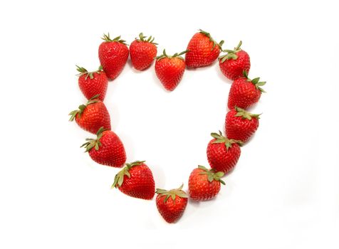 Strawberries shaped to form a heart on white background