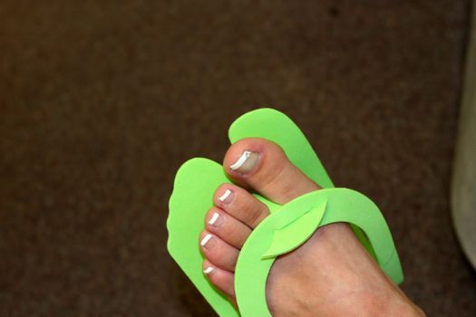 Young woman's foot drying after pedicure