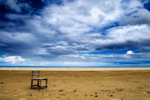 It is a lonely one chair on the beach.