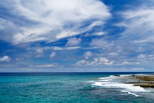 It is a beautiful coral reef rock cape with blue sky in kenting of Taiwan.