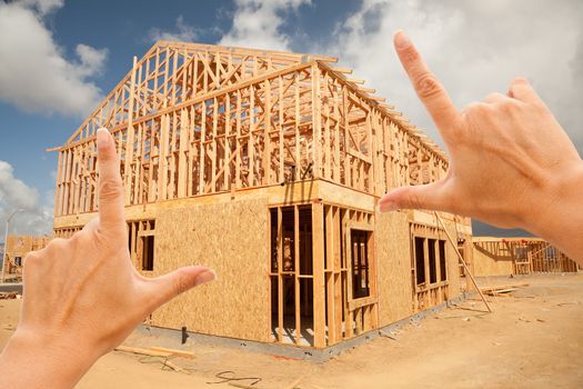 Female Hands Framing New Home Frame on Construction Site.