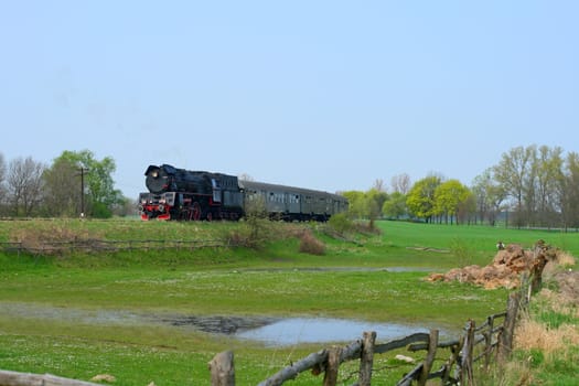Steam retro train passing the countryside