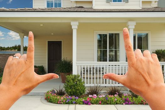 Female Hands Framing Beautiful Newly Constructed House.
