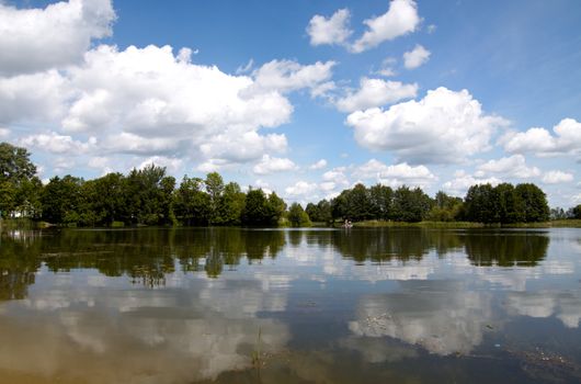 Summer landscape with a lake view, sky and clouds 