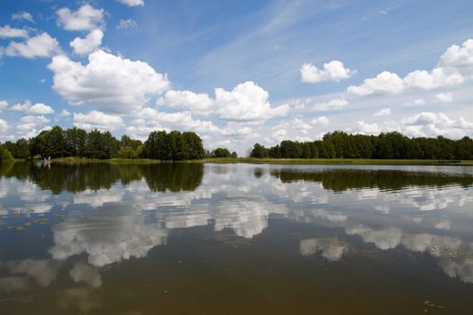 Summer landscape with a lake view, sky and clouds 