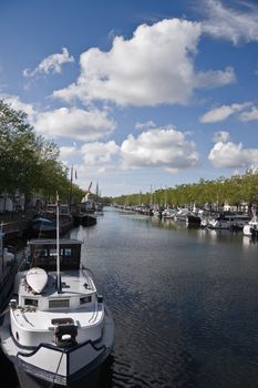 Harbor with ships and blue sky with white clouds on summer day