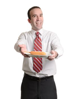 A young businessman showing off his lunch, which is a coated wiener on a stick, isolated against a white background.