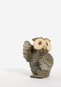 Souvenir owl with lifted wings isolated on a white background