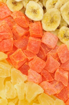 Top view of dried banana slices, papaya and pineapple dices