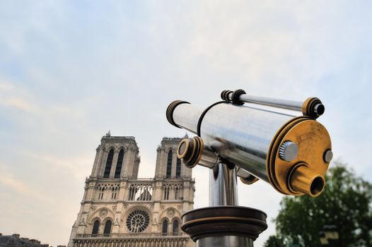 Telescope of stainless steel on against facade Notre-Dame