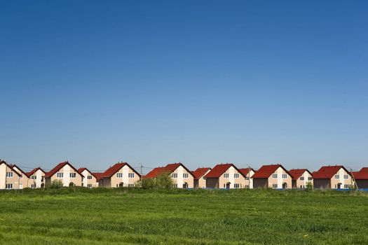 New cottages with red roofs and blue sky