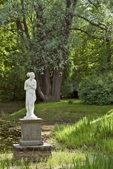 Classical marble woman stature in the park