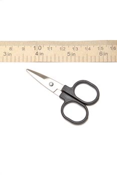 Black scissors and paper measuring tape isolated on white background