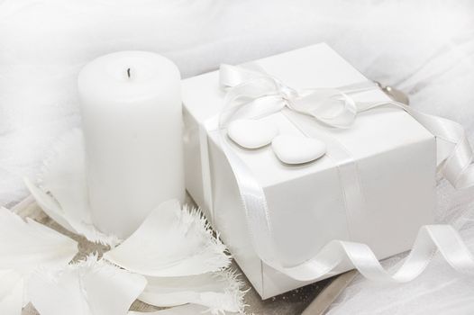 White gift box with candle and tulip