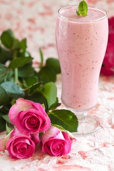 Delicious fresh raspberry smoothie with pink roses