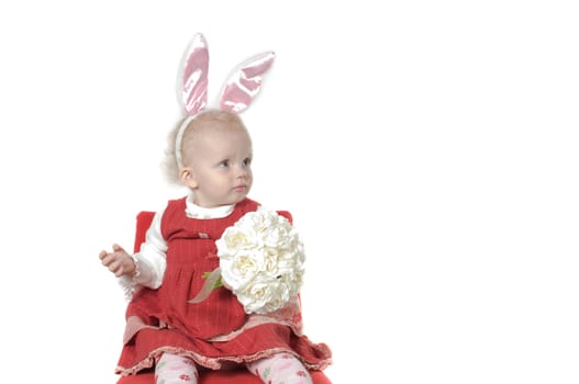 Closeup portrait of little girl with hare ears sitting on the chair