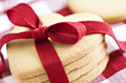 Heart shaped cookies with a red ribbon on a cloth