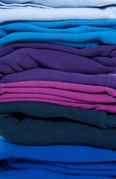 Background of folded blue, purple and indigo clothes.