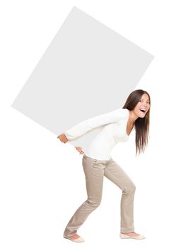 Woman lifting / showing heavy blank billboard sign. Pretty casual woman carrying empty sign board on her back. Funny image of beautiful asian \ caucasian female model isolated in full length on white background.