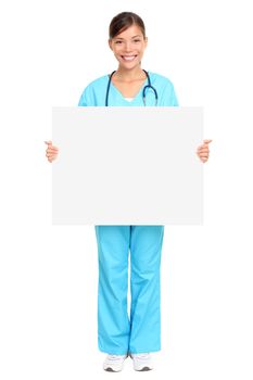 Nurse showing medical sign billboard standing in full length. Young smiling nurse or doctor in scrubs showing empty blank sign board with copy space. Asian Caucasian female model isolated on white background.