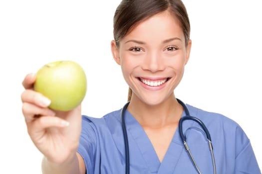 Nurse or young doctor giving an apple smiling. Health care concept isolated on white background.