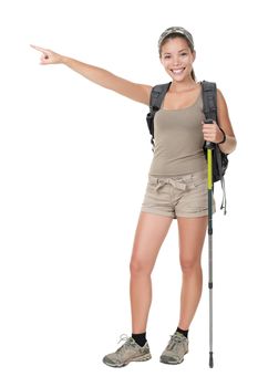 Hiker woman standing isolated. Female hiker pointing. Young woman wearing backpacking bag and hiking poles. Isolated on white background in full length.