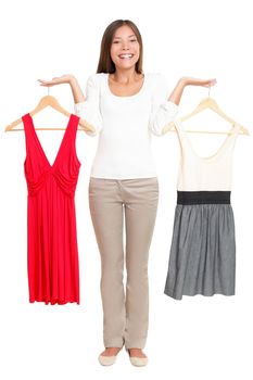 Woman choosing between dresses and can not make decision. Beautiful Asian / Caucasian woman showing clothes isolated on white background in full figure.  