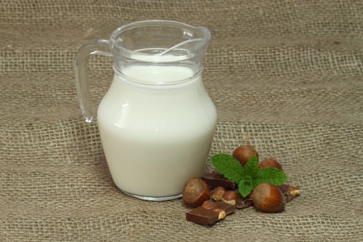 Milk jug on brown background