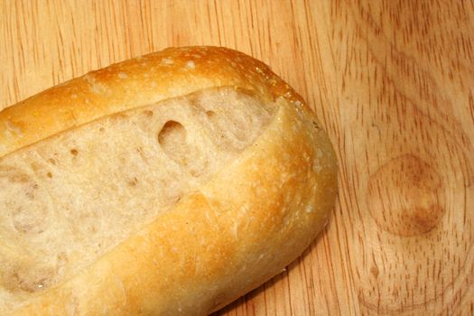 A Fresh bakery roll on a cutting board