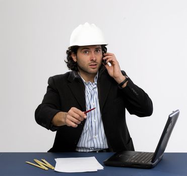 Young architect at work with laptop isolated