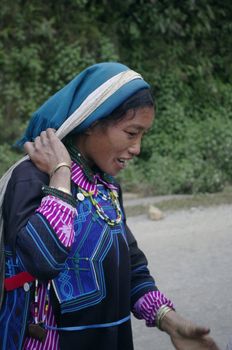 The woman's ethnic(Minority) Ha Nhi live in the high mountains. This woman are hired for porting all types. Away from their village she now work for an owner who wants to enlarge his house. She come up from the sand Valley for masonry in bags which the flange is on their foreheads.