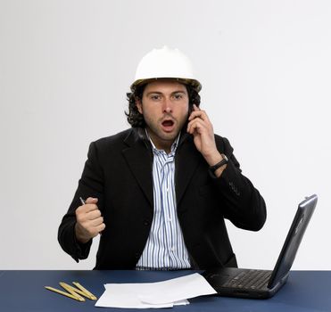 Young architect at work with laptop isolated