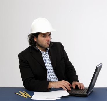 Young architect at work with laptop isolated