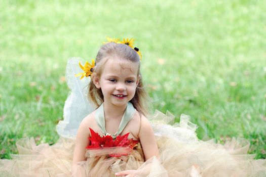 Beautiful happy little girl dressed in a fairy costume.