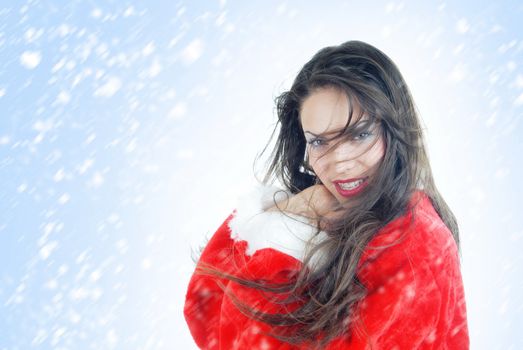 Smiling lady in the red Santa Claus costume on a white and blue background with falling snowflakes