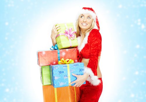 Happy lady in the red Santa Claus costume holding gift boxes on a white and blue background with snow