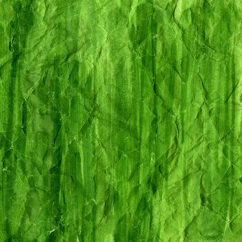 green watercolor background painted with vertical brush strokes on crumpled printing paper, rough texture