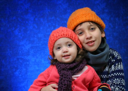 Brother and sister hugging in winter outfit. Look at my gallery for more winter images