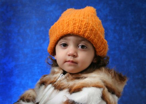 Little girl in winter outfit looking at camera. Look at my gallery for more winter images