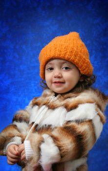 Little girl in winter outfit looking at camera. Look at my gallery for more winter images