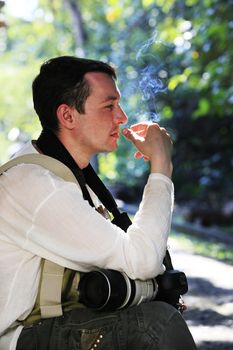 Man with cigarette in summer park