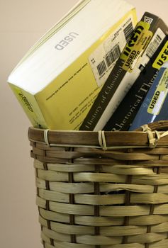 Used books thrown in trash can.