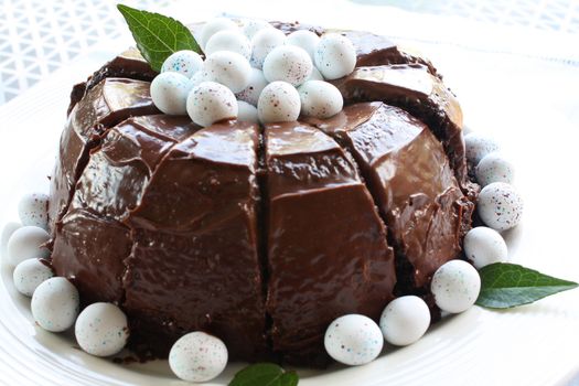 Sliced chocolate cake with mini easter eggs