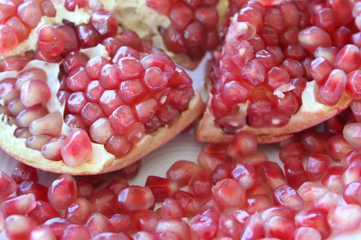 Sliced pomegranite with seeds spilling from it