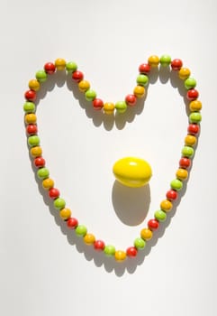 Easter egg and heart forms colored beads around them isolated on a white background