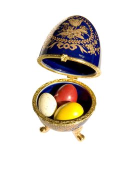 Decoration of Faberge copy with real colored Easter eggs in it isolated on a white background