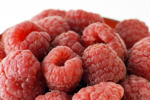 Macro with all the details of plumb ripe delicious and healthy raspberries.
