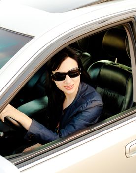 Beautiful young businesswoman in her car after work